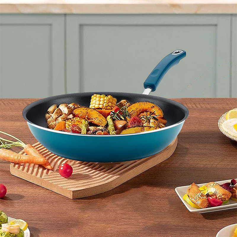 How do nonstick blue outside and black inside woks achieve high-temperature stir-frying without sticking while also protecting the coating from peeling?